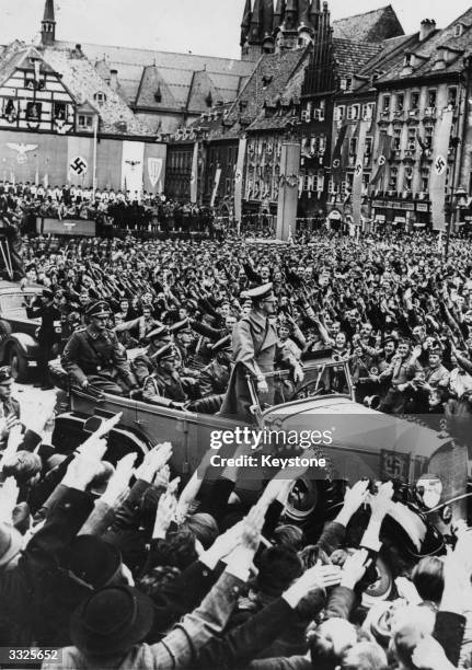 German leader Adolf Hitler tours the Sudentenland, east Germany, in an open top car to a tumultuous welcome. Seated directly behind him is his close...