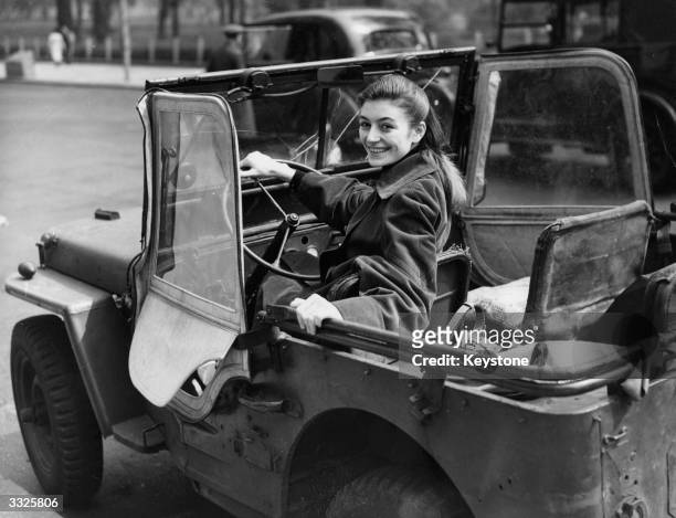 French film actress Anouk Aimee celebrating her birthday with a jeep-drive through London.