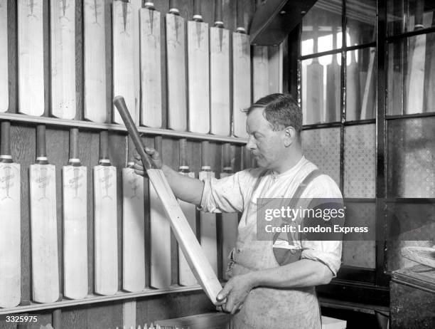 Inspecting cricket bats at the makers before they are graded and stamped.