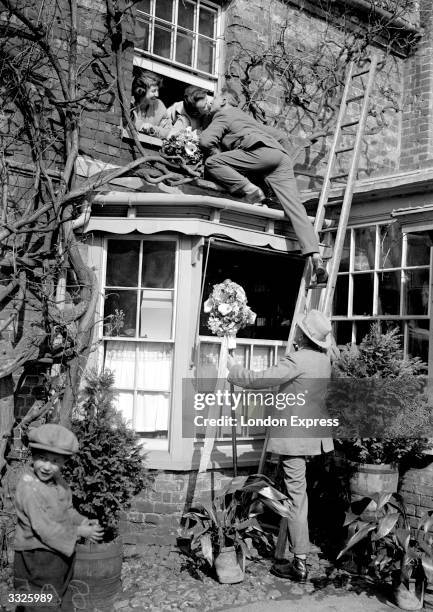 On Hungerford annual 'Tutti' day a young man climbs up to an open window to claim his kiss from the girls within or receive a payment in forfeit.