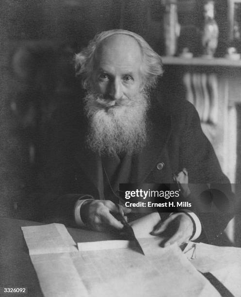 Oarsman and racing-boat designer Frederick James Furnivall clips an item from a newspaper. Furnivall helped to found the Working Men's College in...