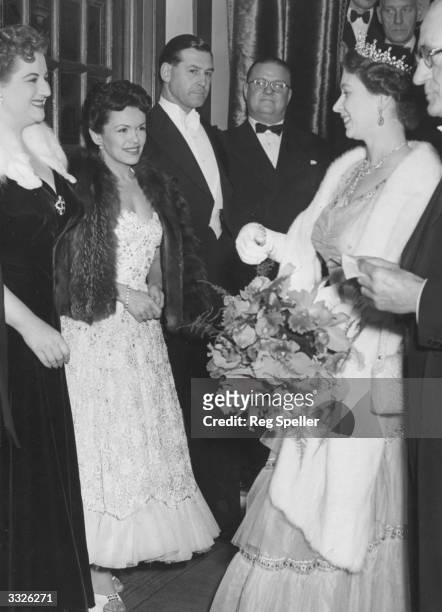 Queen Elizabeth II talks to Anne Shelton and Eve Boswell , members of the cast of 'Guys and Dolls', after the Royal Variety Performance at the London...