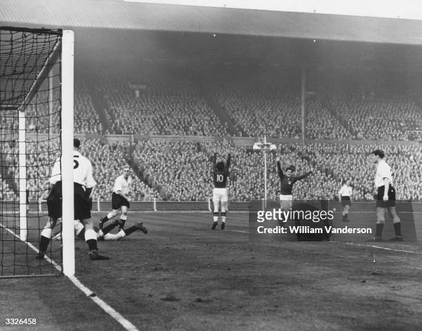 Hungary's third goal is scored by the team captain Ferenc Puskas during their match against England at Wembley Stadium.