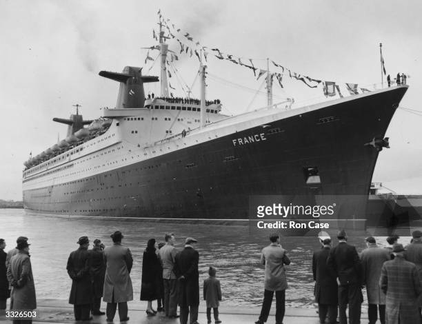 People on the quayside watch as the new 1035 ft French passenger liner 'France' manoeuvres out of the Ocean Terminal at Southampton, on her way home...