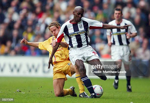 Lloyd Dyer of West Bromwich Albion is tackled by Danny Spiller of Gillingham during the Nationwide Division One match between West Bromwich Albion...
