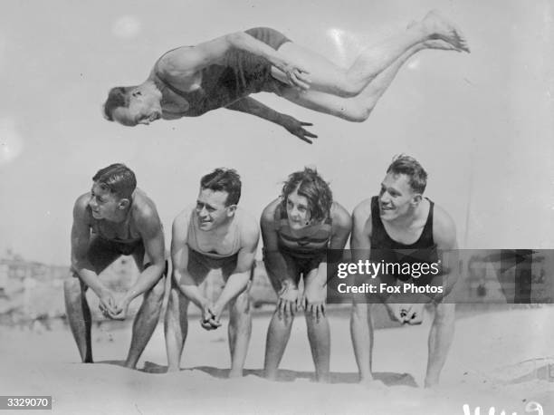 Acrobatic feats by Australian swimmers on Sydney Beach.