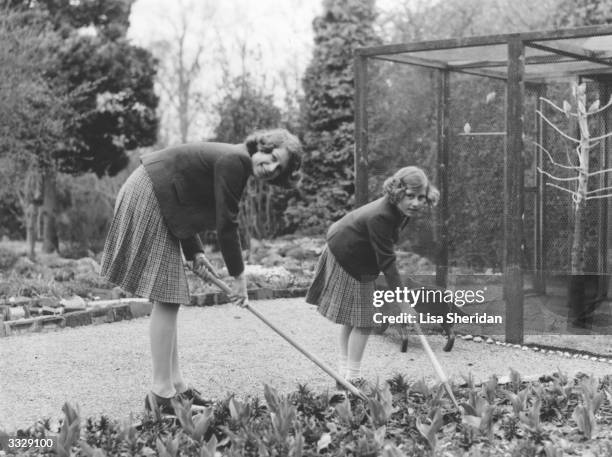 Queen Elizabeth II , as Princess Elizabeth, and her younger sister Princess Margaret Rose working in the garden at Royal Lodge, Windsor, which they...