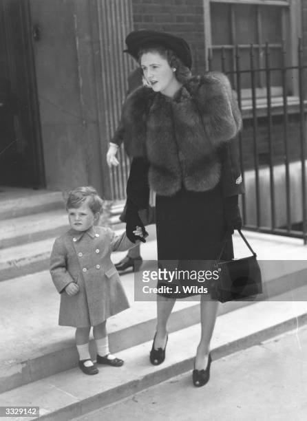 Politician Winston Churchill leaves home with his mother Pamela Churchill . Young Winston is acting as a page to Lady Sarah Churchill at her wedding.