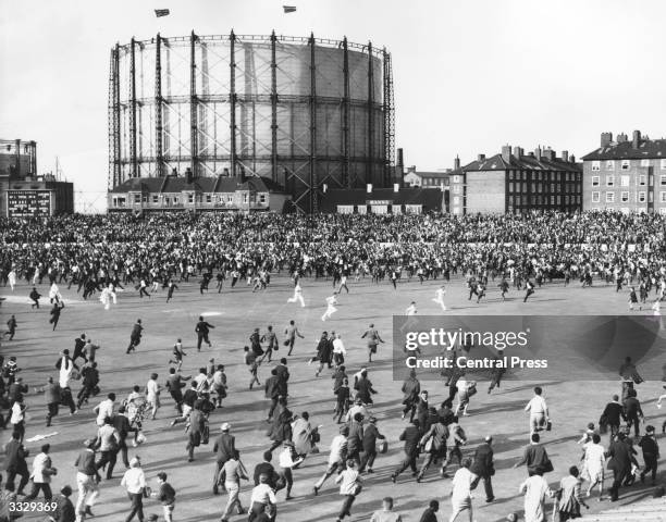 Cricketers sprint to the safety of the pavilion as crowds of spectators stormed onto the pitch after the West Indies won the Final Test match by...