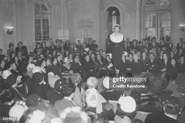 Guests watching a fashion show of a collection by Christian Dior.