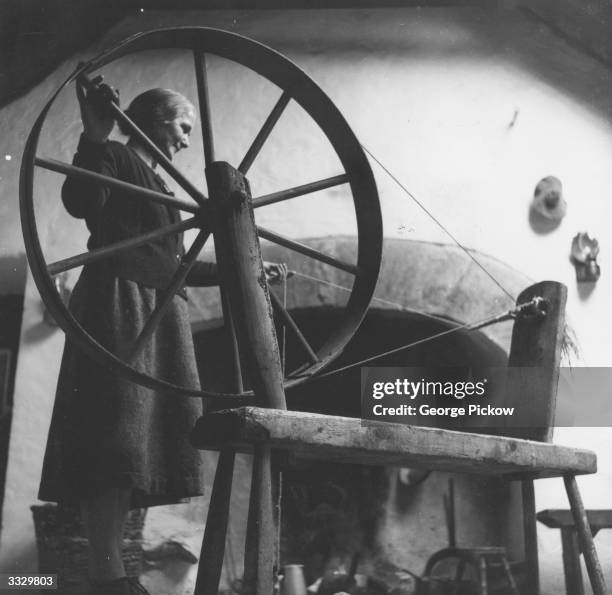 Mrs Bartley Hernon twists the threads of spun wool in preparation for a long winter of knitting at Kilmurvy on Inishmore, one of the Aran Islands off...