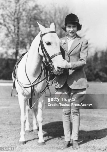 Princess Elizabeth with a horse at Windsor on her 13th birthday.