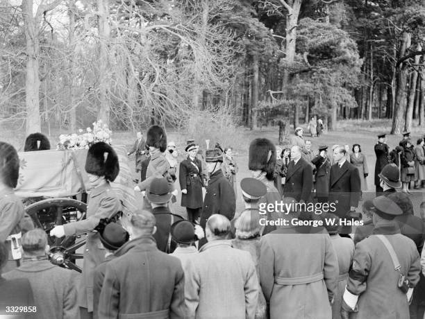 The Dukes of Gloucester and Edinburgh walking behind the funeral cortege on the crowd-lined country road from Sandringham Church to Wolferston...