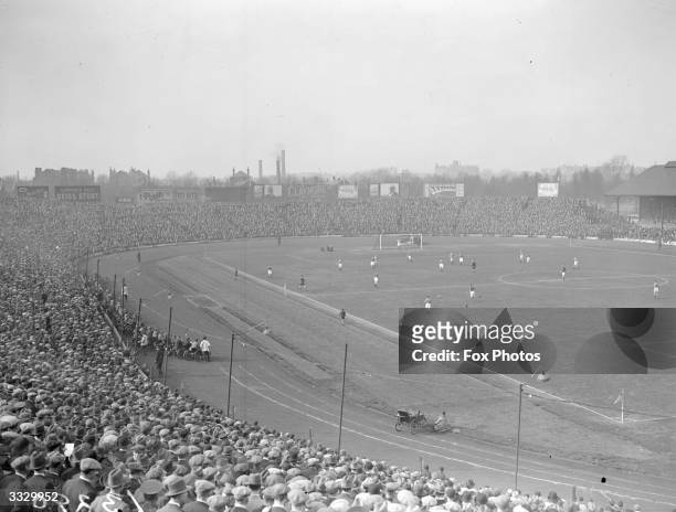 Crowd watching a game in progress at Chelsea football ground.