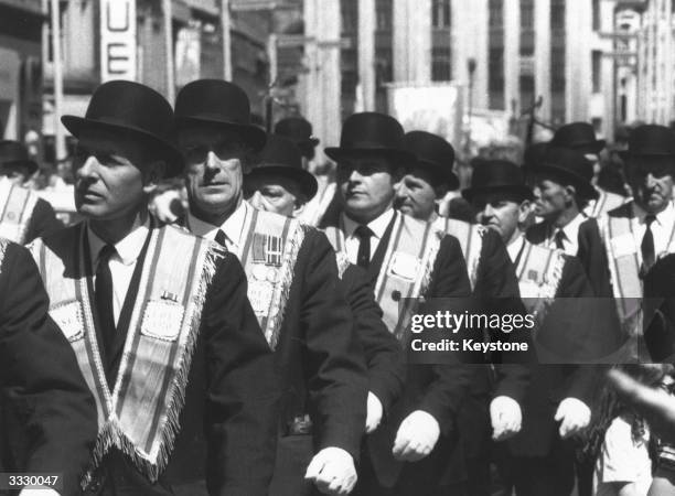 Group of the Orange Order march through Belfast to celebrate the defeat of Catholic forces in the Battle of the Boyne in 1690.