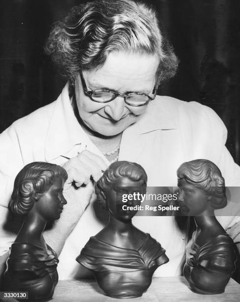 Mrs Maud Woolley putting the final touches to black basalt busts of Queen Elizabeth II at the Wedgwood factory, Stoke-on-Trent. Wedgwood are...