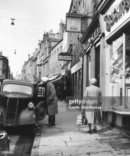 Street scene in the city of Dundee. Dundee, situated on the banks of the dSilvery Tayf, is linked to Fife and the south of Scotland by a road bridge,...