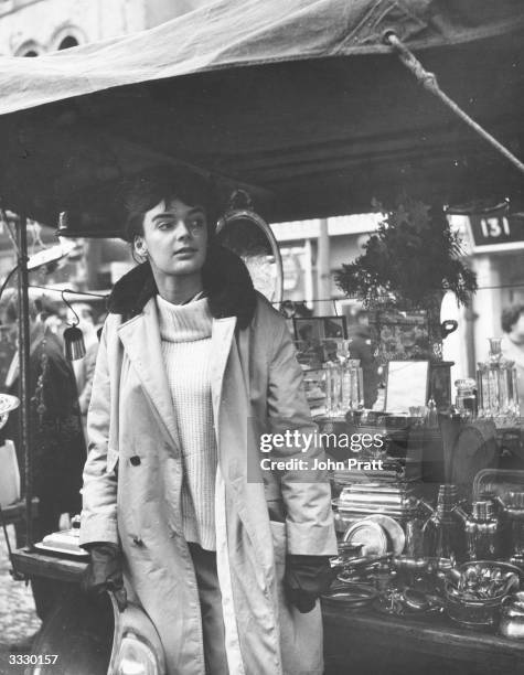 Film actress Barbara Steele on duty at a stall in Portobello Road market, west London.