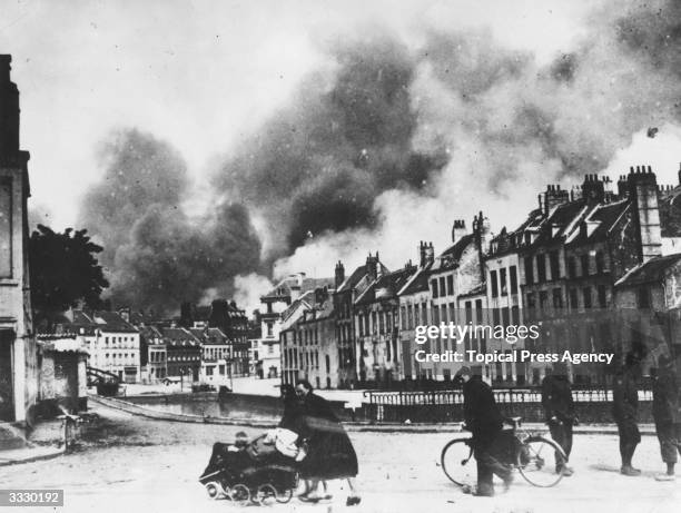 Refugees fleeing during the German aerial bombardment of Dunkirk.