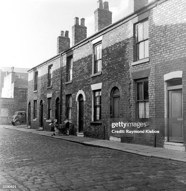 Houses at Salford, Manchester, whose owners have disappeared and the tenants pay no rents. Original Publication: Picture Post - 8127 - The Housing...