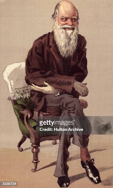 English naturalist Charles Darwin propped up on two cushions and in the wheeled chair he used for propelling himself round his work room. Vanity Fair...