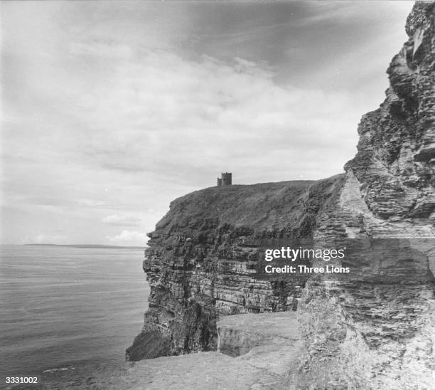 The Moher Cliffs which rise 700 feet above the Atlantic, near Limerick, Ireland. O'Briens tower stands on the furthermost cliff.