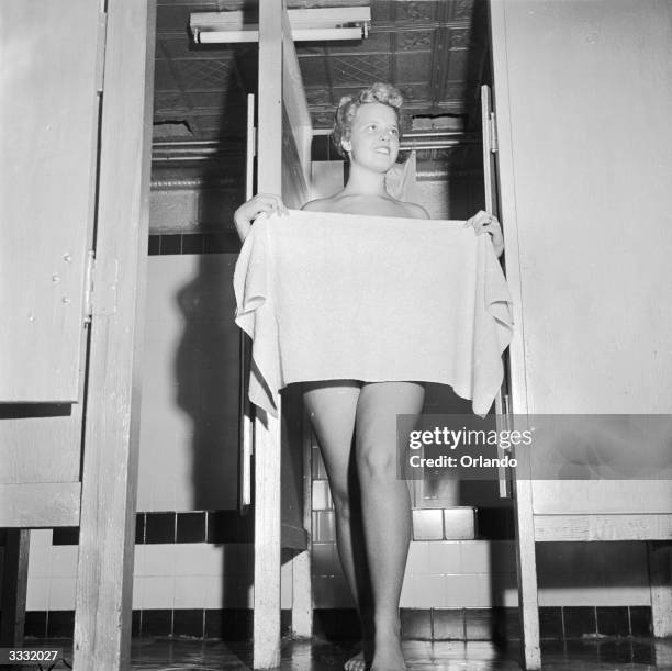 Resident of the Metropolitan Trailer community of Moonachie, New Jersey, baths at the trailer town's shower facility.