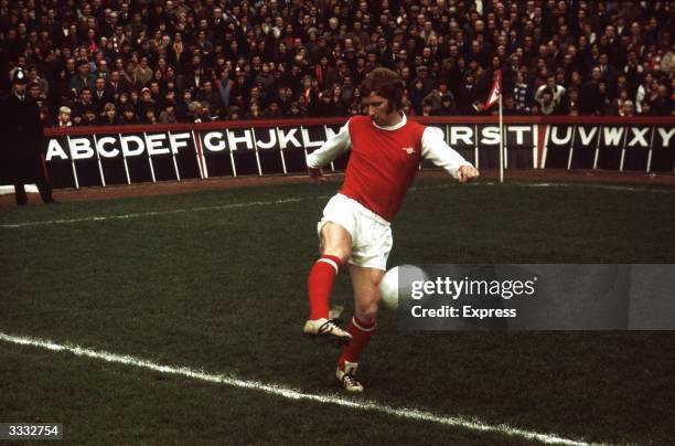 Arsenal FC midfield player Alan Ball kicking the ball before a match.