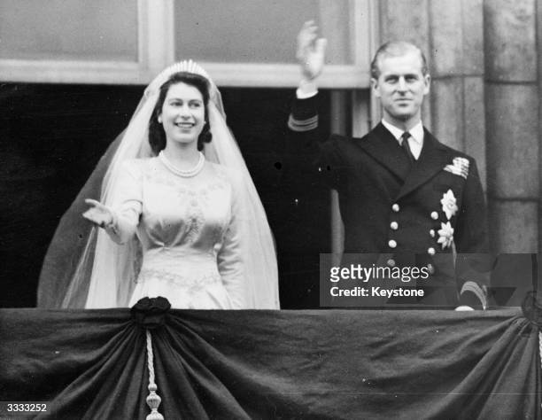 Princess Elizabeth and Prince Philip, Duke of Edinburgh waving to a crowd from the balcony of Buckingham Palace, London, shortly after their wedding...