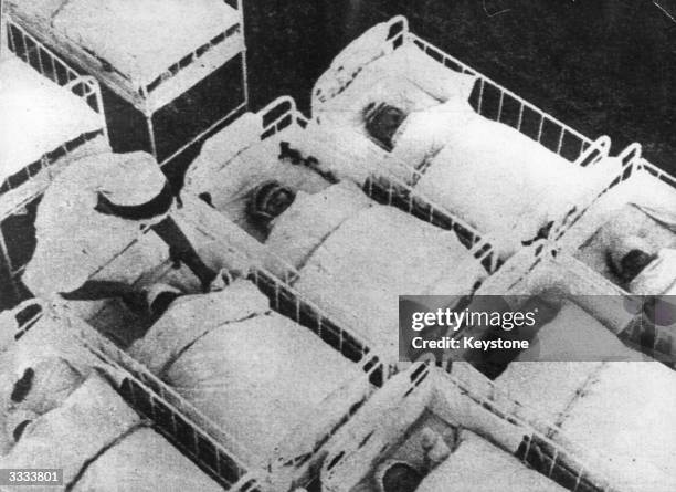 Babies in cots in a dormitory at a German unwed mothers home, where 'Aryan' youngsters, Hitler's perfect youth, were encouraged.