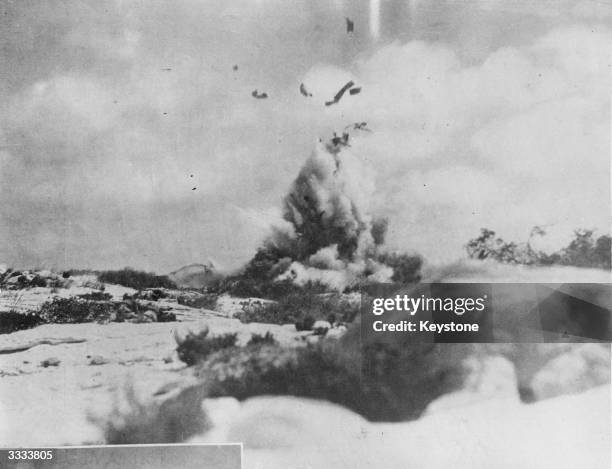 During a battle in the West Desert of Africa, Nazi soldiers on the left duck as a tank is blown to bits by Allied fire.