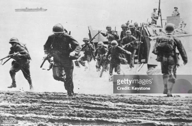 American marines coming ashore from landing craft at Guadalcanal.