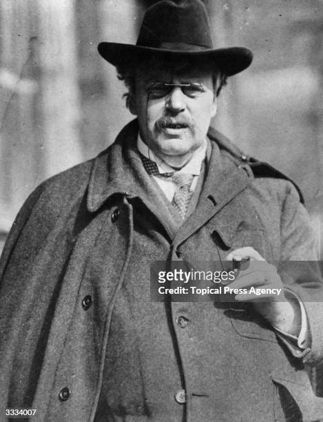 Author, G K Chesterton in his familiar outfit of broad-brimmed hat, cloak and pince-nez.