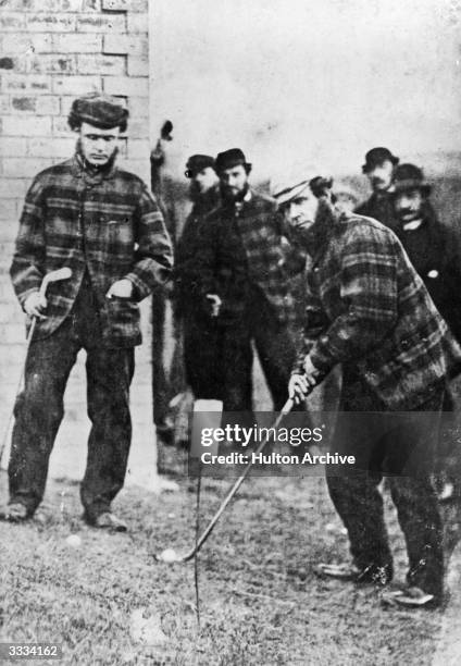 British golfers 'Old' Tom Morris and Charlie Hunter at a match at Prestwick, Ayrshire. 'Old' Tom and his son 'Young' Tom became the only father and...