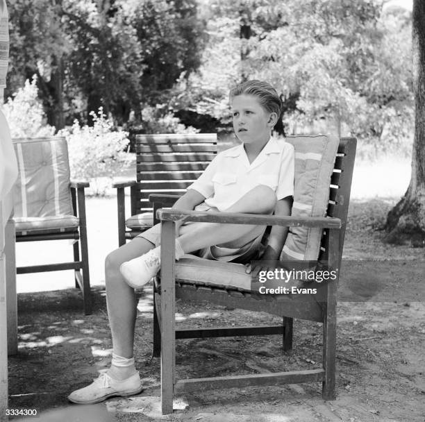 Crown Prince Constantine of Greece sitting in the garden at the royal summer residence in southern Greece.