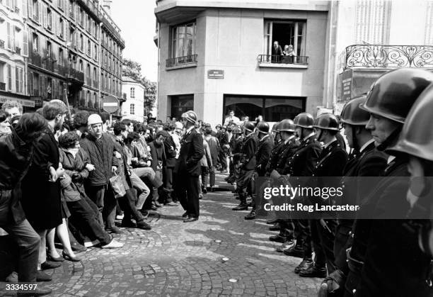 Armed police face a crowd of student demonstrators during the student riots at Paris.