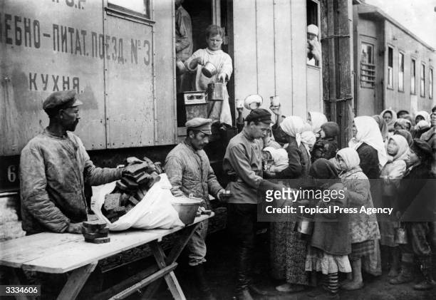 Americans distribute food from a relief train during the famine at the time of the Russian Civil War.