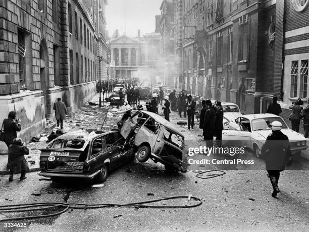 Police and firemen in front of the Criminal Court and Army Recruiting office in Whitehall where an IRA bomb exploded, killing one man and injuring...