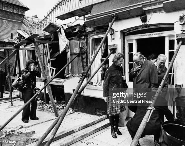 Home secretary Roy Jenkins leaving the wrecked Horse and Groom public house in Guildford two days after an IRA bomb exploded, killing five people and...