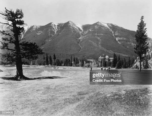 Golfers on the 15th Green of the Banff Springs golf course.