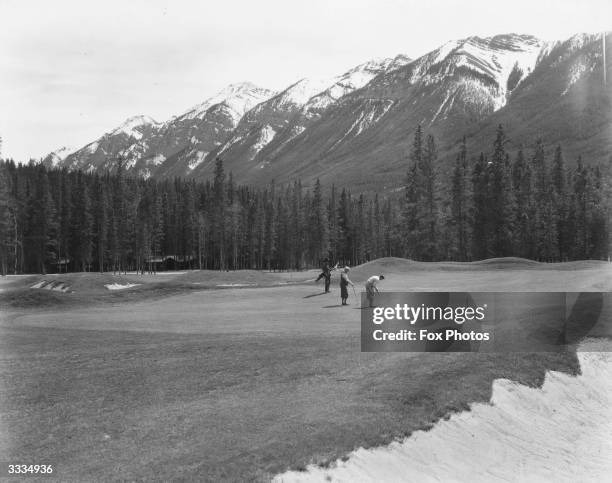 Golfers on the 17th Green of the Banff Springs golf course.