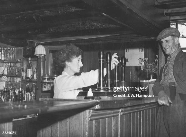Mrs Peacock, the licensee of the Black Lion pub at Southfleet in Kent, serves a customer. A traditional old-style establishment, the Black Lion...