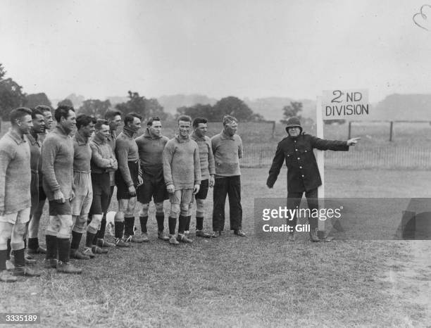 Plymouth Argyle FC trainer Tommey Haynes as a points duty policeman directing the way to promotion. Left to right Leslie, Pullen, Jack, Cock, Forbes,...