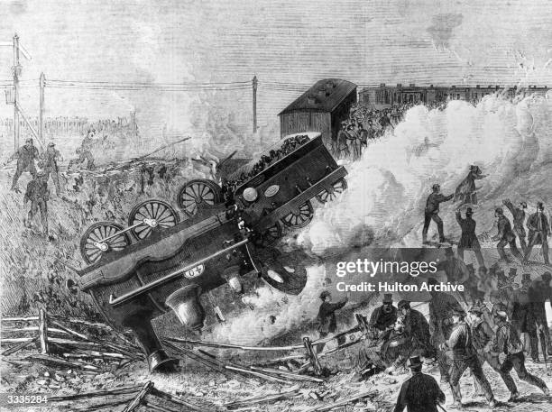 Rescue workers surround an overturned engine after a railway accident on the Brighton Railway near Clapham Junction, London. Original Publication:...