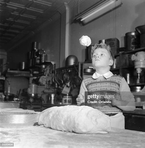 Child actor Glenn Walken flipping dough at his home in Bayside, Long Island.