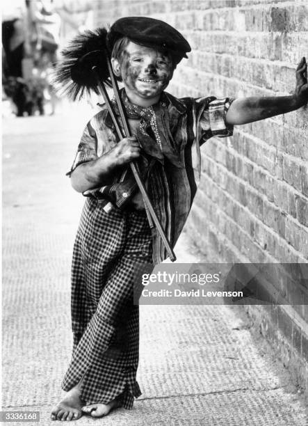Four year-old Tommy Stafford dressed as a chimney-sweep for the fancy-dress competition at the East Street Market centenary celebrations, London.