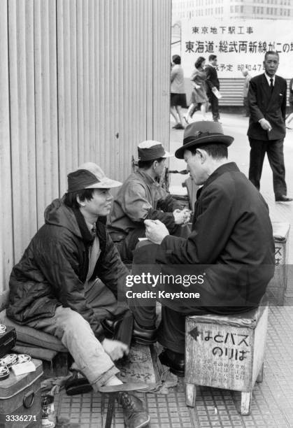 Part-time artist Koichi Akahira supports himself as a bootblack outside the main Tokyo railway station.