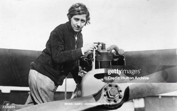 English aviatrix Amy Johnson at work on an aeroplane.