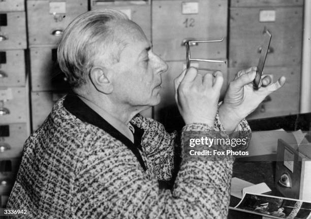 Hitler's photographer, Heinrich Hoffmann examining a negative.