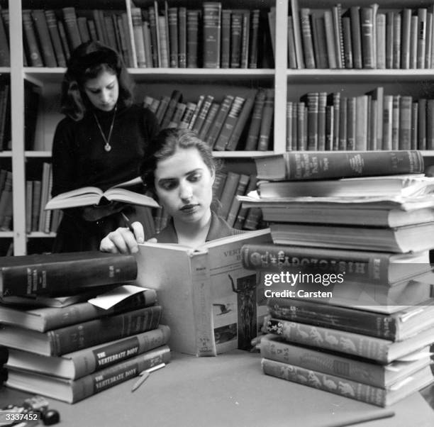 Student at Sarah Lawrence College in New York, with a pile of books.